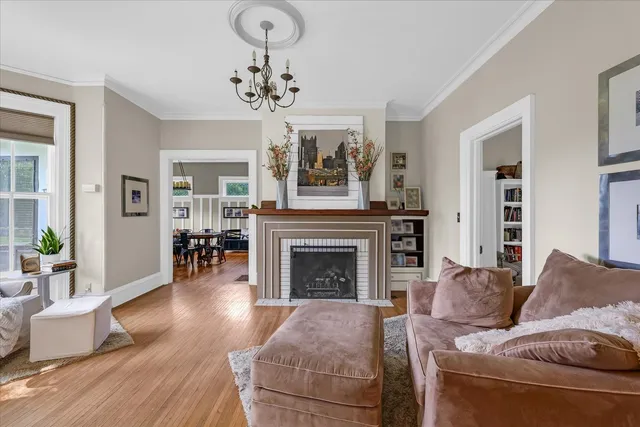 a living room with furniture and a chandelier