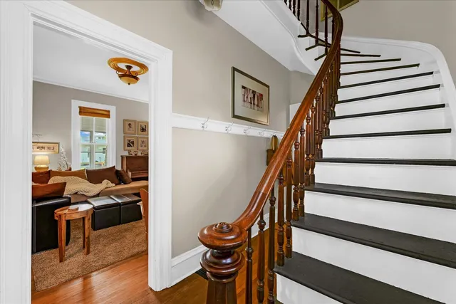 a living room with furniture a rug and a large window