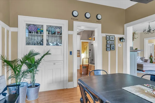 a kitchen with a sink dishwasher white cabinets and chairs
