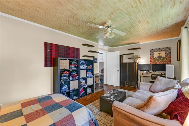 a room with bookshelf and a two windows