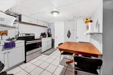 a kitchen with stainless steel appliances cabinets and a table
