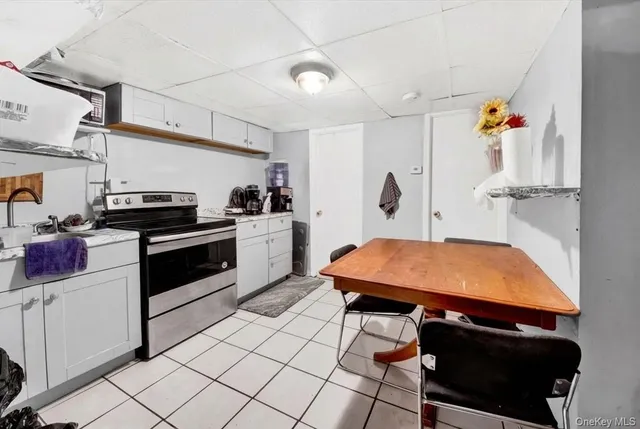 a kitchen with stainless steel appliances cabinets and a table