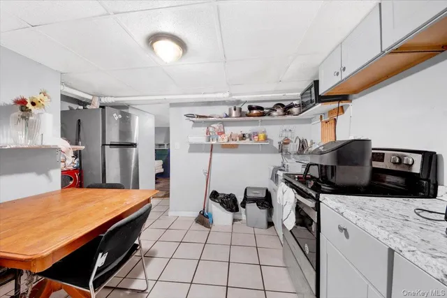 a kitchen with stainless steel appliances granite countertop a sink and a refrigerator