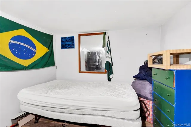 a bedroom with a bed and dresser