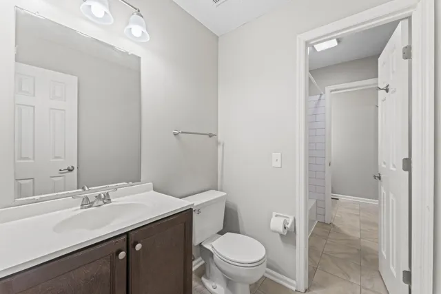 a bathroom with a sink a toilet a shower and a mirror