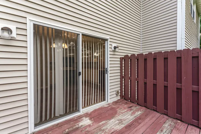 a view of a backyard with wooden fence