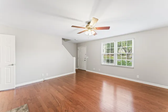 wooden floor in an empty room with a window