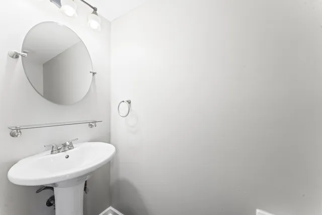 a bathroom with a sink a mirror and vanity