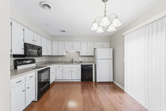 a kitchen with a white cabinets and stainless steel appliances
