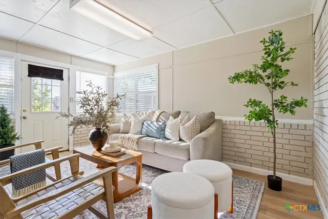 a living room with furniture and a potted plant