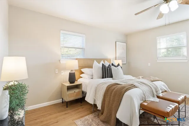 a bedroom with a bed and wooden floor