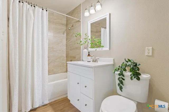 a bathroom with a sink mirror and toilet