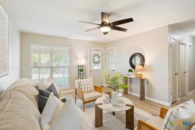 a living room with furniture and a large window