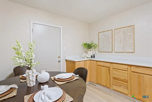 a dining room with furniture and wooden floor