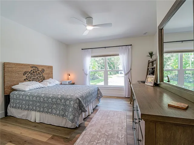 a bedroom with a large bed and a large window