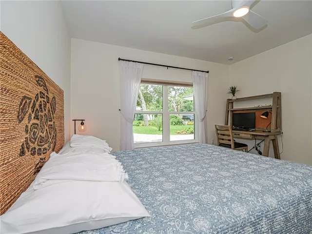 a living room with a bed furniture and a flat tv screen