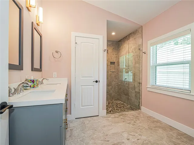 a bathroom with a sink vanity granite and a mirror