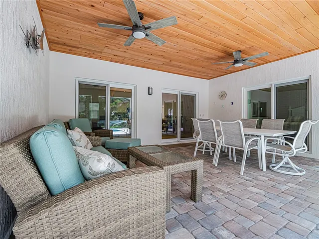 a outdoor space with lots of chairs and a dining table