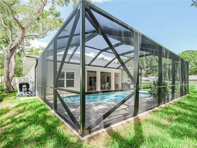 a view of a house with backyard and porch
