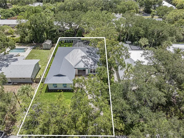 an aerial view of house with yard swimming pool and outdoor seating