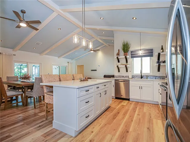 a kitchen with a sink stainless steel appliances and cabinets