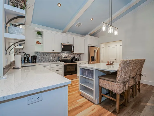 a kitchen with a sink appliances and cabinets