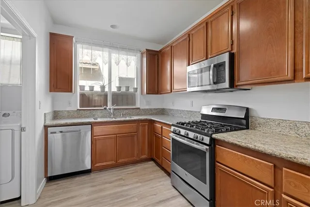 a kitchen with stainless steel appliances granite countertop a stove and a sink