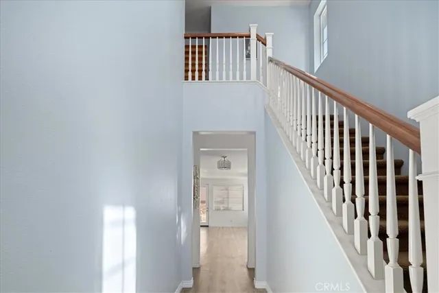 a view of staircase with wooden floor and a window
