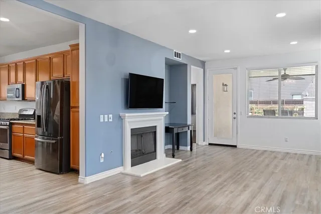 a view of a kitchen with a sink stove refrigerator and cabinets