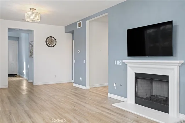 a view of a livingroom with an empty space and a fireplace