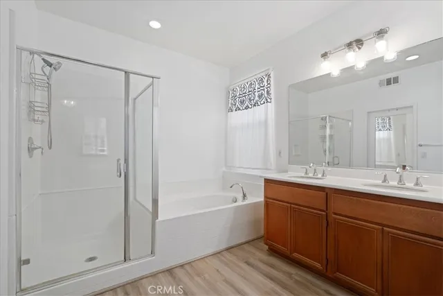 a bathroom with a tub a sink shower and mirror