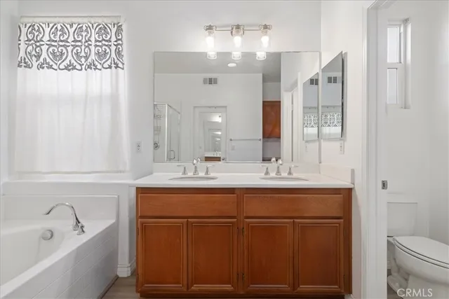 a bathroom with a sink a toilet and bathtub