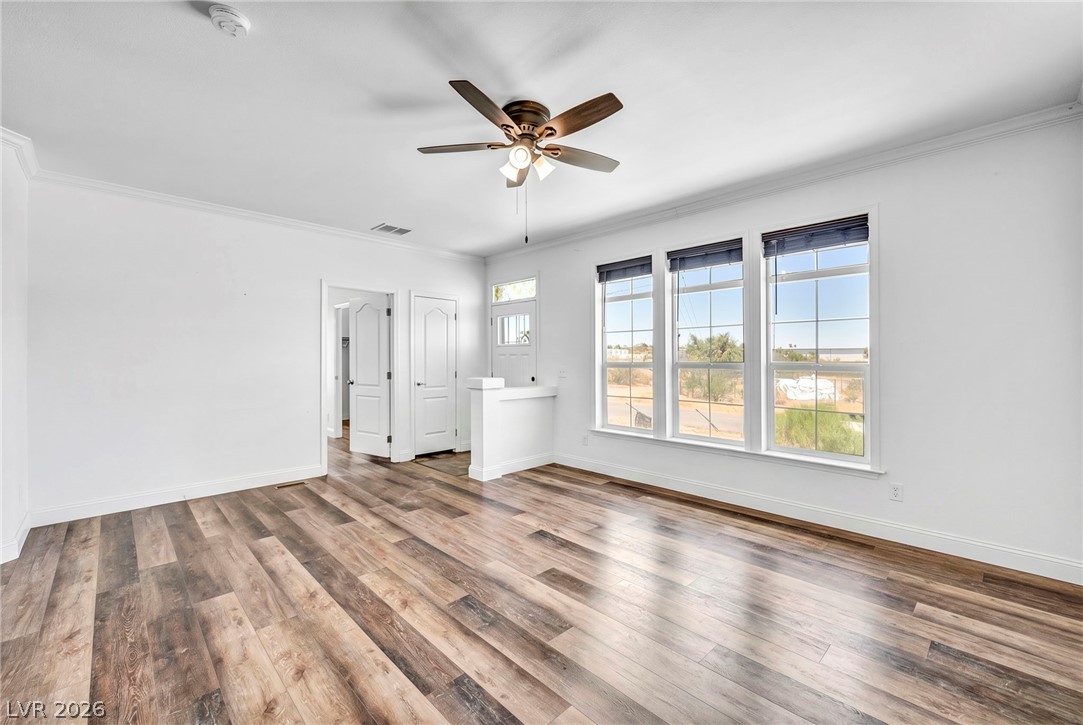 225 California Street Searchlight, NV 89046 - Photo 16 of 64 A generous living area features warm wood flooring and ample natural light through multiple windows.