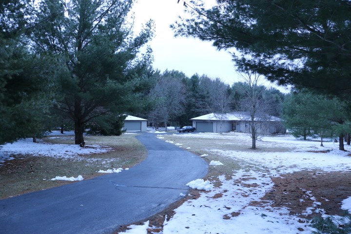 a view of a yard with wooden fence
