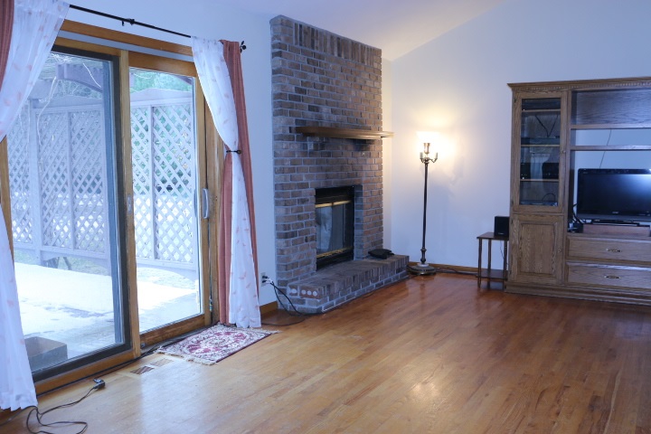 3442 Yale Bridge Road Rockton, IL 61072 - Photo 8 of 27 a view of an empty room with wooden floor and a fireplace