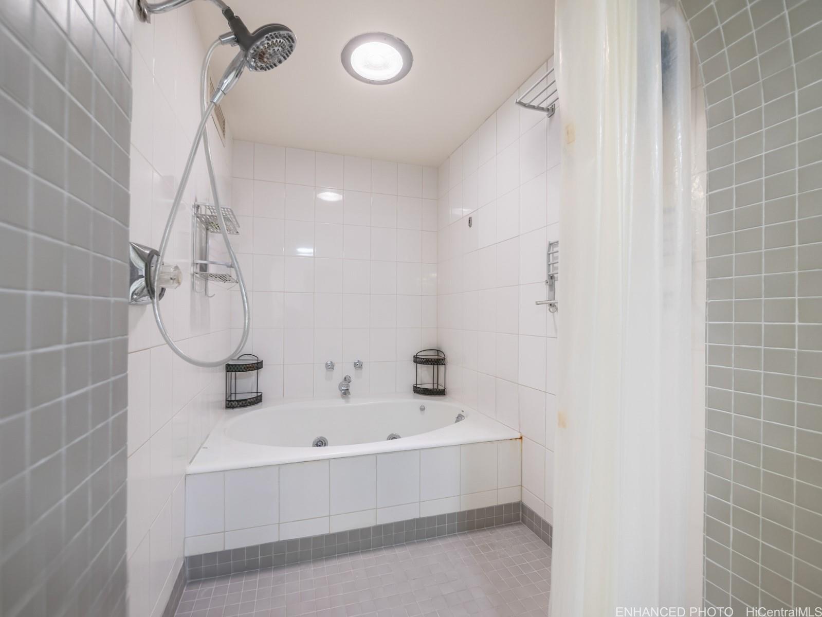 425 South Street, Unit 501 Honolulu, HI 96813 - Photo 15 of 25 a bathroom with a bathtub and a shower