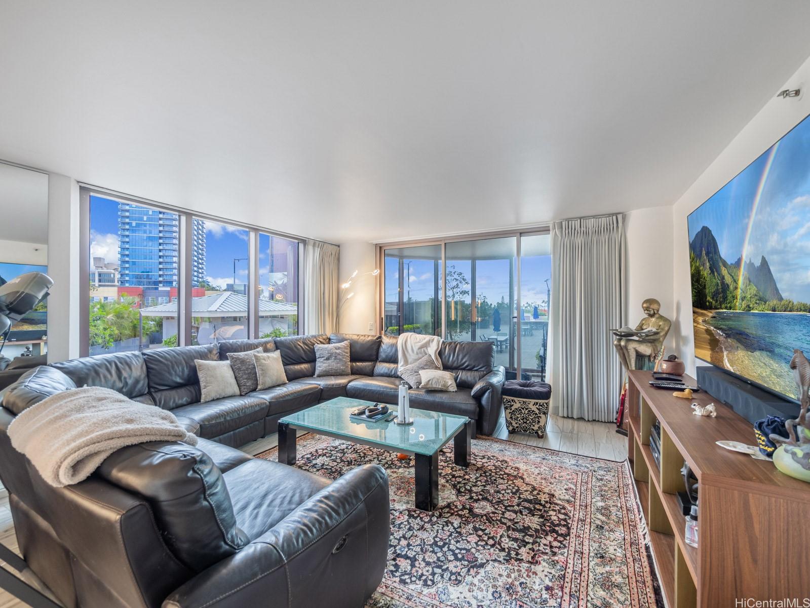 425 South Street, Unit 501 Honolulu, HI 96813 - Photo 2 of 25 a living room with furniture flat screen tv and a large window