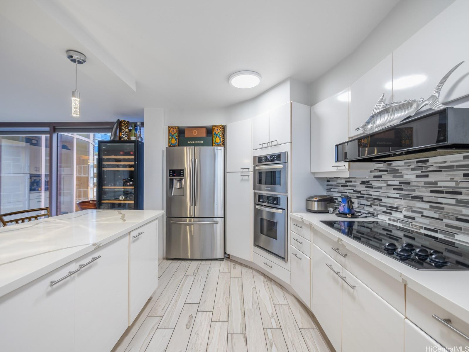 425 South Street, Unit 501 Honolulu, HI 96813 - Photo 4 of 25 a kitchen with stainless steel appliances a refrigerator and a stove top oven