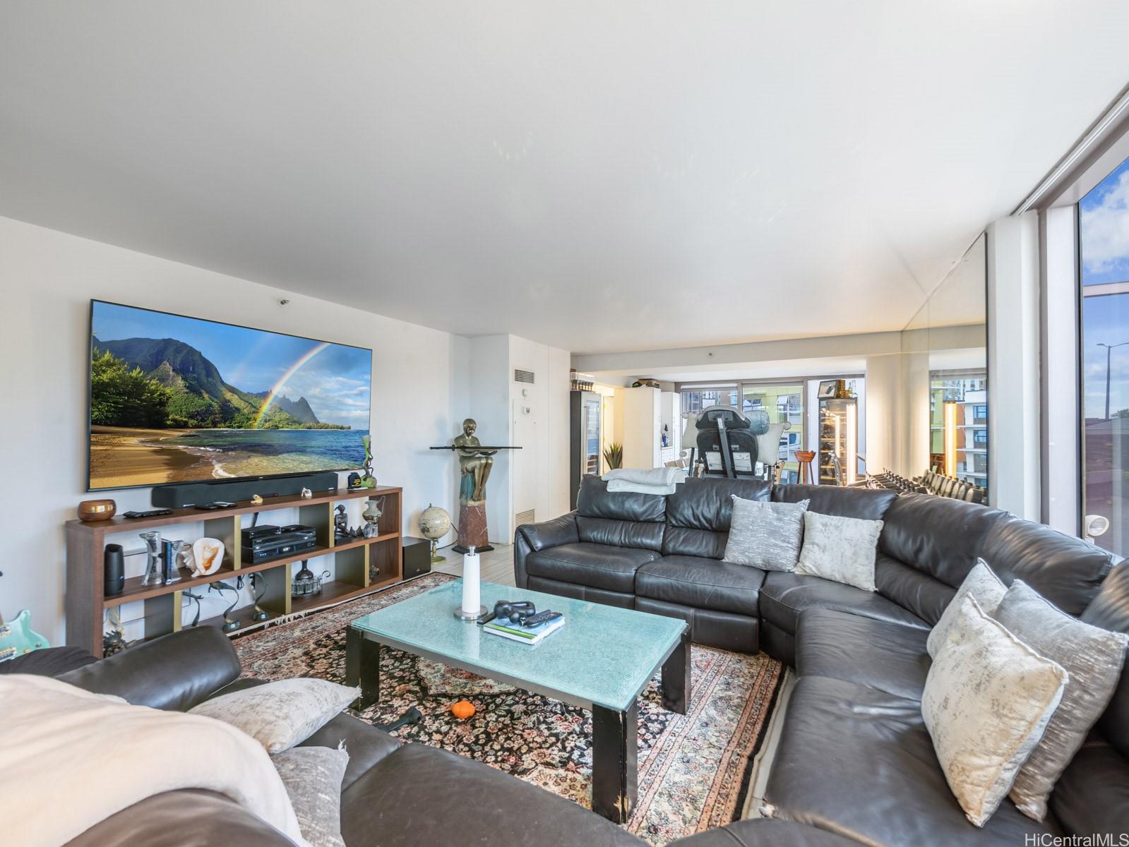 425 South Street, Unit 501 Honolulu, HI 96813 - Photo 7 of 25 a living room with furniture and a flat screen tv