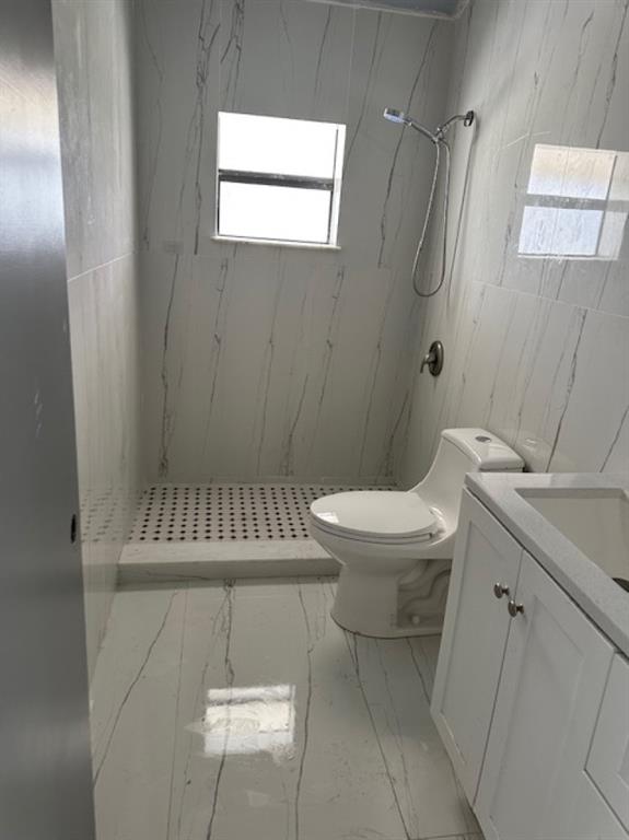 24001 Southwest 202nd Avenue Homestead, FL 33031 - Photo 14 of 17 a bathroom with a toilet a sink and mirror