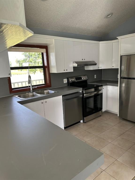24001 Southwest 202nd Avenue Homestead, FL 33031 - Photo 7 of 17 a kitchen with stainless steel appliances a sink stove and cabinets