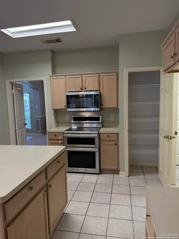 a kitchen with a refrigerator and a sink