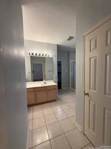a bathroom with a tub shower and sink