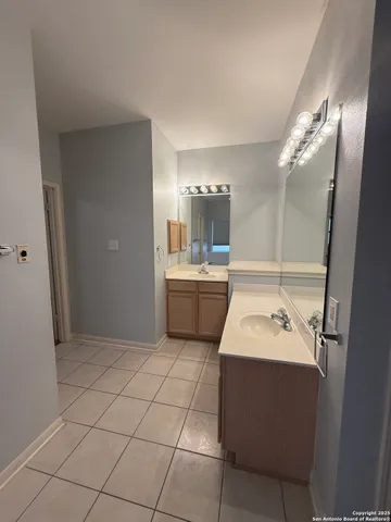 a bathroom with a sink a toilet a mirror and vanity