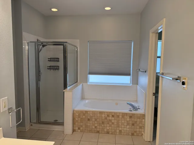 a bathroom with a bathtub and shower
