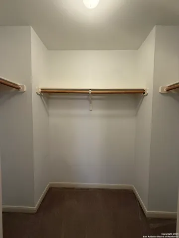 a view of a room with furniture and wooden floor