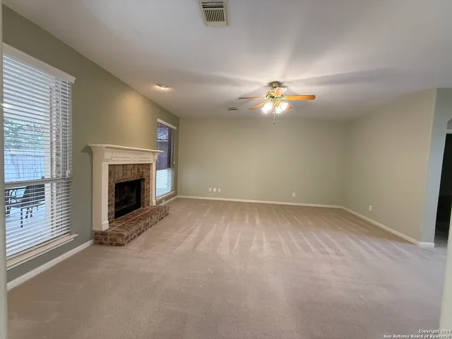 wooden floor in an empty room with a fireplace