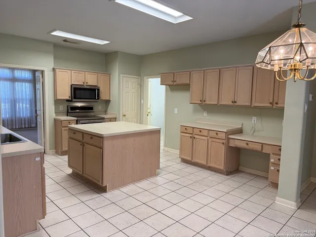 a kitchen with a stove top oven and cabinets