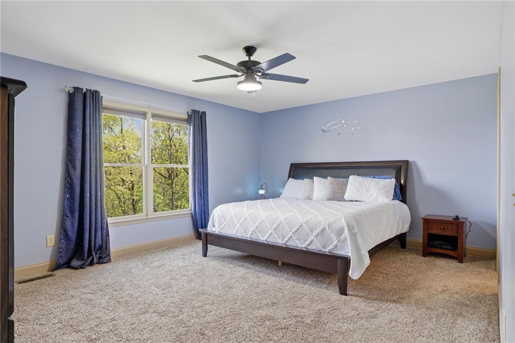3326 Monument Road Jasper, GA 30143 - Photo 15 of 49 a bed sitting in a spacious bedroom next to a window