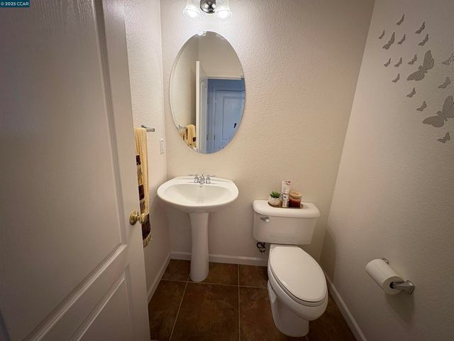 a bathroom with a sink toilet and a mirror